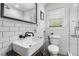 Bathroom featuring black fixtures, white subway tile, glass shower doors, and a vessel sink at 2240 Cheshire Bridge Ne Rd # 206, Atlanta, GA 30324