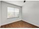 An empty bedroom with hardwood floors, fresh paint, and a large window at 2240 Cheshire Bridge Ne Rd # 206, Atlanta, GA 30324