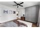 Well-lit bedroom features modern ceiling fan, wood floors, large wardrobe, and unique decor at 2240 Cheshire Bridge Ne Rd # 206, Atlanta, GA 30324
