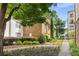 Building exterior with stone accents, fresh landscaping, and sidewalk at 2240 Cheshire Bridge Ne Rd # 206, Atlanta, GA 30324