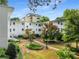 Exterior view of apartments with mature trees, shrubs and walkways at 2240 Cheshire Bridge Ne Rd # 206, Atlanta, GA 30324