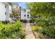 Apartment building exterior with manicured garden path and lush landscaping at 2240 Cheshire Bridge Ne Rd # 206, Atlanta, GA 30324