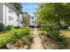 Apartment building exterior with manicured garden path and lush landscaping at 2240 Cheshire Bridge Ne Rd # 206, Atlanta, GA 30324