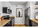 Galley kitchen featuring stainless steel appliances, white cabinetry, granite countertops, and a wood backsplash at 2240 Cheshire Bridge Ne Rd # 206, Atlanta, GA 30324