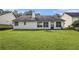 The large backyard features a flat, grassy area great for outdoor activities at 2397 Cove Lake Rd, Lithonia, GA 30058