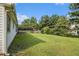 Expansive backyard features lush green grass, mature trees, and privacy fence at 2397 Cove Lake Rd, Lithonia, GA 30058