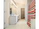 Bathroom featuring dual sink vanity, a large mirror, and a striped shower curtain at 2397 Cove Lake Rd, Lithonia, GA 30058