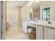 Bright bathroom with dual sinks, white cabinetry, and large mirror at 2397 Cove Lake Rd, Lithonia, GA 30058