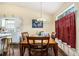 Light filled dining room with adjacent kitchen, wooden table set, and bright windows at 2397 Cove Lake Rd, Lithonia, GA 30058