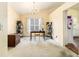 Dining room with large window, chandelier, table with chairs, and ample space for entertaining at 2397 Cove Lake Rd, Lithonia, GA 30058
