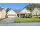 Charming single-story home with well-maintained lawn, a two-car garage, and welcoming curb appeal at 2397 Cove Lake Rd, Lithonia, GA 30058