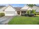 Well-maintained single-story home features a 2-car garage, mature landscaping, and welcoming front porch at 2397 Cove Lake Rd, Lithonia, GA 30058