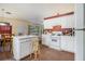 Kitchen and dining area, featuring white cabinets and island, open to the living room at 2397 Cove Lake Rd, Lithonia, GA 30058