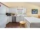 Well-lit kitchen featuring white cabinets, stainless steel appliances, and functional layout at 2397 Cove Lake Rd, Lithonia, GA 30058