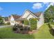 A charming single-story home featuring an attached two-car garage and lush, manicured landscaping at 2397 Cove Lake Rd, Lithonia, GA 30058