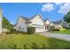 The home has a well-manicured lawn, a two-car garage, and tidy landscaping at 2397 Cove Lake Rd, Lithonia, GA 30058