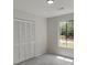 Bright bedroom featuring a large window and closet with paneled doors, creating a calming and organized space at 4912 Bayside Ct, Stone Mountain, GA 30088