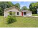 Charming one-story home with manicured lawn, bright red front door, and large picture windows at 4912 Bayside Ct, Stone Mountain, GA 30088