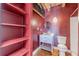 Bathroom featuring red painted walls, hardwood floors, open shelving, a vanity sink, and a toilet at 63 Mangum Sw St # 3, Atlanta, GA 30313