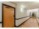 Apartment hallway leading to unit #3 with hardwood floors and neutral paint at 63 Mangum Sw St # 3, Atlanta, GA 30313