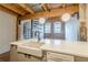 Kitchen island with a farm sink, dishwasher, and view of spiral staircase with exposed brick at 63 Mangum Sw St # 3, Atlanta, GA 30313