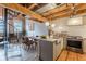 Open-concept kitchen with island seating, stainless steel range, exposed brick, and spiral staircase at 63 Mangum Sw St # 3, Atlanta, GA 30313