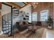 Inviting living room features exposed brick wall, spiral staircase, and a comfortable seating area at 63 Mangum Sw St # 3, Atlanta, GA 30313