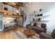 Stylish living room with hardwood floors, spiral staircase, and open shelving above a comfortable gray couch at 63 Mangum Sw St # 3, Atlanta, GA 30313