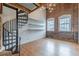 Living room features exposed brick, hardwood floors, and a spiral staircase at 63 Mangum Sw St # 3, Atlanta, GA 30313