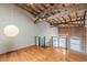 Loft area features wood floors, exposed beams, and views of exposed brick at 63 Mangum Sw St # 3, Atlanta, GA 30313