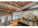 Cozy main bedroom loft with exposed wood beams, brick accent wall, and natural light at 63 Mangum Sw St # 3, Atlanta, GA 30313