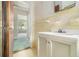 This bathroom features a white vanity, window, and an open doorway at 1206 Tuckawanna Sw Dr, Atlanta, GA 30311