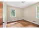 This bedroom features a window, overhead light, and hard wood floors at 1206 Tuckawanna Sw Dr, Atlanta, GA 30311
