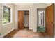 This bedroom features a window, hardwood floors and open closet at 1206 Tuckawanna Sw Dr, Atlanta, GA 30311