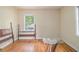 This bedroom has hardwood floors, two windows, and a doorway at 1206 Tuckawanna Sw Dr, Atlanta, GA 30311