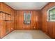 Bedroom featuring wood-paneled walls, neutral carpet, an air conditioning unit, and a window with a view of the outside at 1206 Tuckawanna Sw Dr, Atlanta, GA 30311