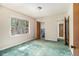 Bedroom features a window and doorway to an adjacent bathroom, and green carpeting at 1206 Tuckawanna Sw Dr, Atlanta, GA 30311