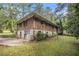 The exterior elevation features stone and brickwork, with a driveway and wooded area at 1206 Tuckawanna Sw Dr, Atlanta, GA 30311