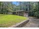 An eye-level view of this brick home showing the side yard, a partial view of the backyard, and a one car garage at 1206 Tuckawanna Sw Dr, Atlanta, GA 30311