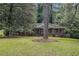 An eye-level view of this single story brick home showcasing the large front lawn, shady tree, and paved walkway at 1206 Tuckawanna Sw Dr, Atlanta, GA 30311