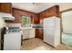 This kitchen features a gas range, plenty of wood cabinetry, and natural light at 1206 Tuckawanna Sw Dr, Atlanta, GA 30311