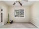 An empty living room with neutral paint, carpeted floors, a ceiling fan, and a view of the front yard through the window at 1206 Tuckawanna Sw Dr, Atlanta, GA 30311