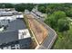Aerial view showcases a new residential area with modern apartments, townhomes, and landscaped green spaces at 1991 Deco Dr, Kennesaw, GA 30144