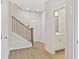 Bright hallway featuring beautiful hardwood floors and stylish staircase with white trim and iron spindles at 1991 Deco Dr, Kennesaw, GA 30144