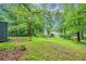 Lush backyard with mature trees offering a serene setting for relaxation and outdoor enjoyment at 2419 Anderson Mill Rd, Austell, GA 30106