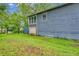 Sprawling backyard with lush lawn, storage shed, and attached garage at 2419 Anderson Mill Rd, Austell, GA 30106