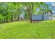 Expansive backyard with mature trees and lush lawn, providing a private outdoor space at 2419 Anderson Mill Rd, Austell, GA 30106