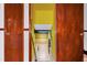 Basement stairwell with wooden doors leading to a partially finished basement space at 2419 Anderson Mill Rd, Austell, GA 30106