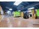 Spacious basement with wood-look floors, wood shelving, and colorful accent walls at 2419 Anderson Mill Rd, Austell, GA 30106