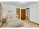 Well-lit bedroom with neutral decor, including a bed, side tables, and wall art at 2419 Anderson Mill Rd, Austell, GA 30106
